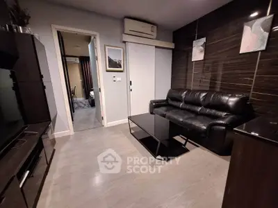 Modern living room with sleek black leather sofa and stylish decor