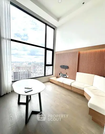 Stunning modern living room with floor-to-ceiling windows and breathtaking city view.