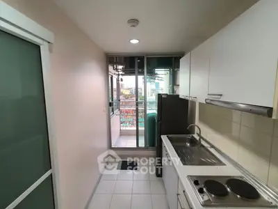 Modern kitchen with sleek cabinetry and balcony access