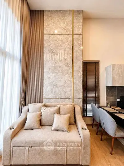 Luxurious modern living room with elegant sofa and dining area, featuring high ceilings and stylish decor.