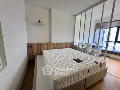 Modern bedroom with large window and minimalist decor in urban apartment