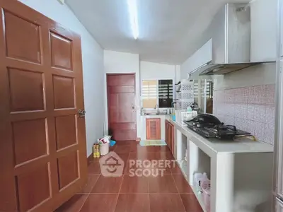 Charming kitchen with gas stove and wooden cabinetry, perfect for culinary enthusiasts.