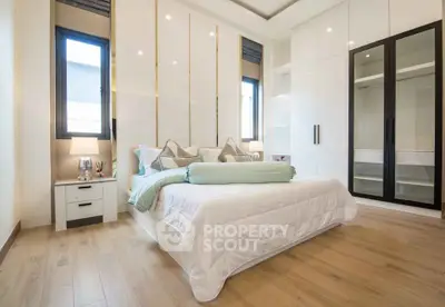 Luxurious bedroom with modern design, spacious wardrobe, and elegant decor