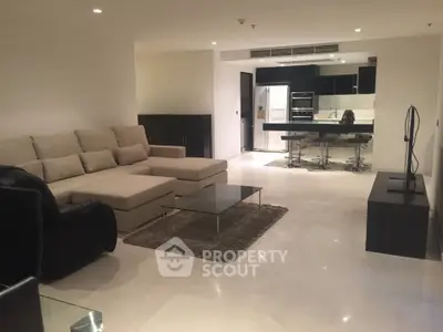 Spacious modern living room with open kitchen and sleek furnishings