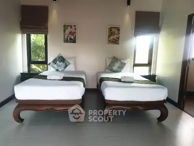 Elegant bedroom with twin beds and stylish decor, perfect for a serene retreat.