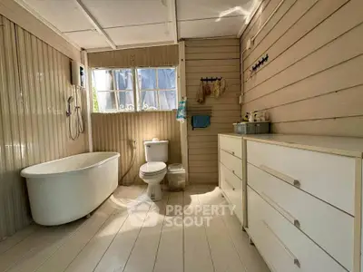 Charming rustic bathroom with freestanding bathtub and natural light