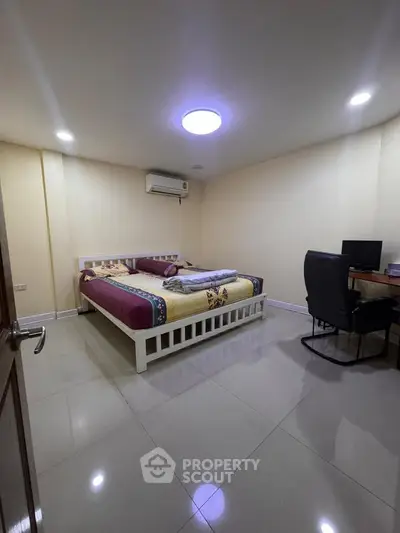 Spacious bedroom with modern furnishings and ample lighting, perfect for comfort and relaxation.