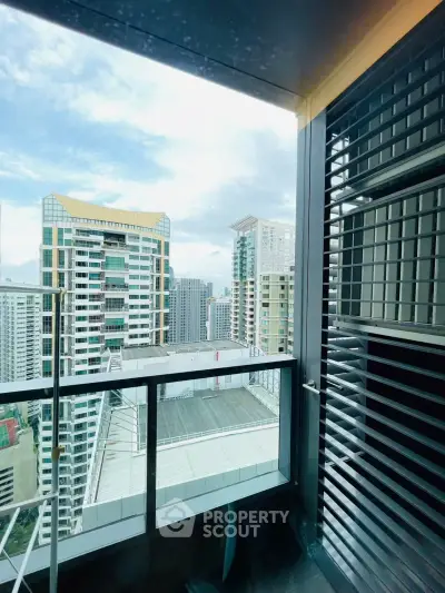 Stunning high-rise balcony view with modern cityscape and sleek architectural design.