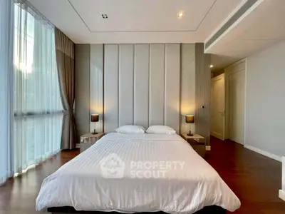 Luxurious bedroom with elegant decor and large windows in modern apartment