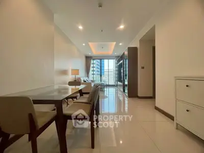 Spacious modern living room with dining area and city view, perfect for urban living.