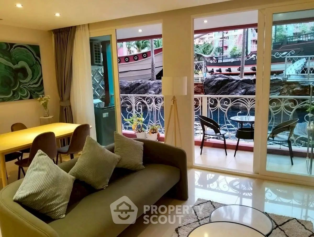 Stylish living room with balcony overlooking unique boat-themed view.