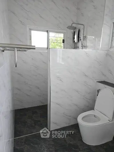 Modern bathroom with sleek marble tiles and contemporary fixtures