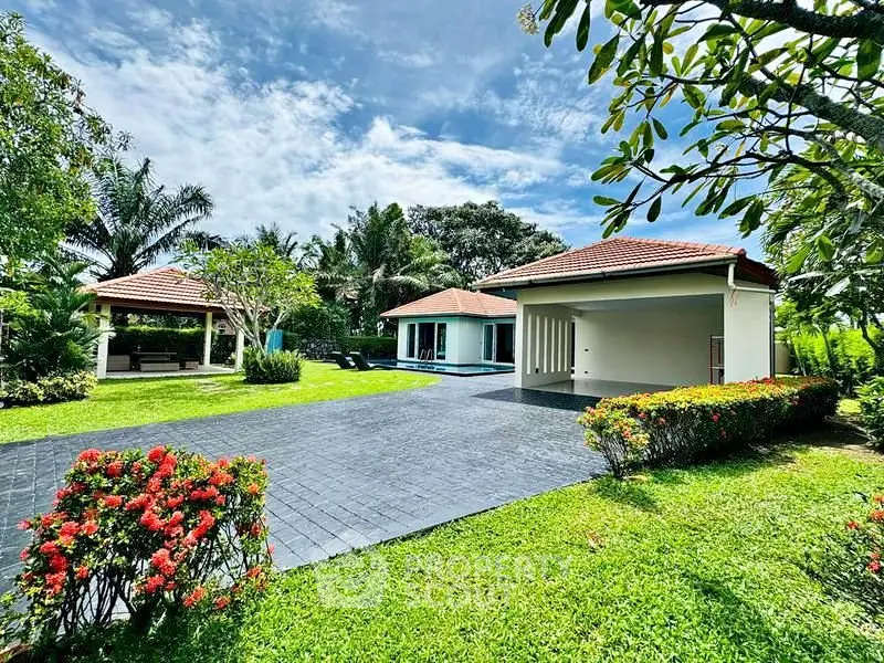 Stunning tropical villa with lush garden and spacious driveway, perfect for serene living.
