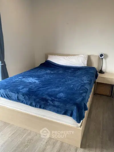 Cozy bedroom with modern bed and stylish decor, perfect for relaxation.