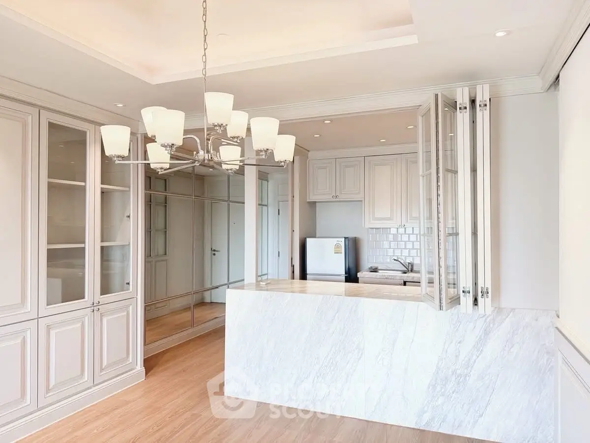 Elegant kitchen with marble countertop and chandelier lighting