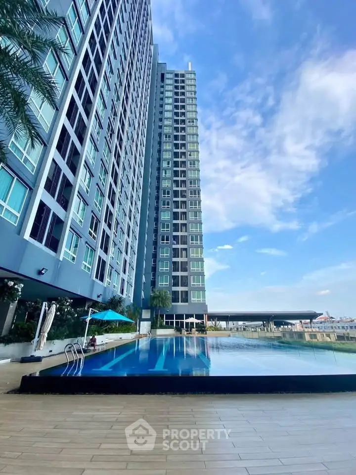 Stunning high-rise building with luxurious pool and breathtaking city views.