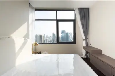 Modern bedroom with city view, featuring large window and stylish furniture, perfect for urban living.