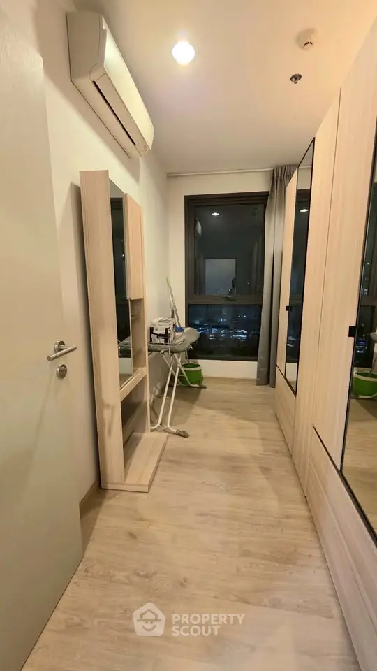 Modern storage room with wooden flooring and city view window