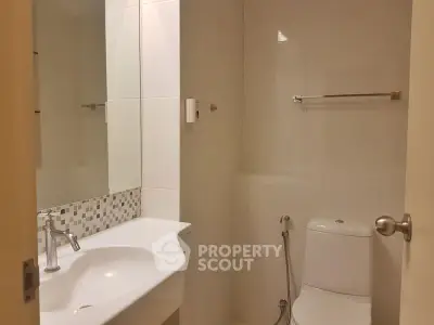 Modern bathroom with sleek fixtures and elegant tile accents