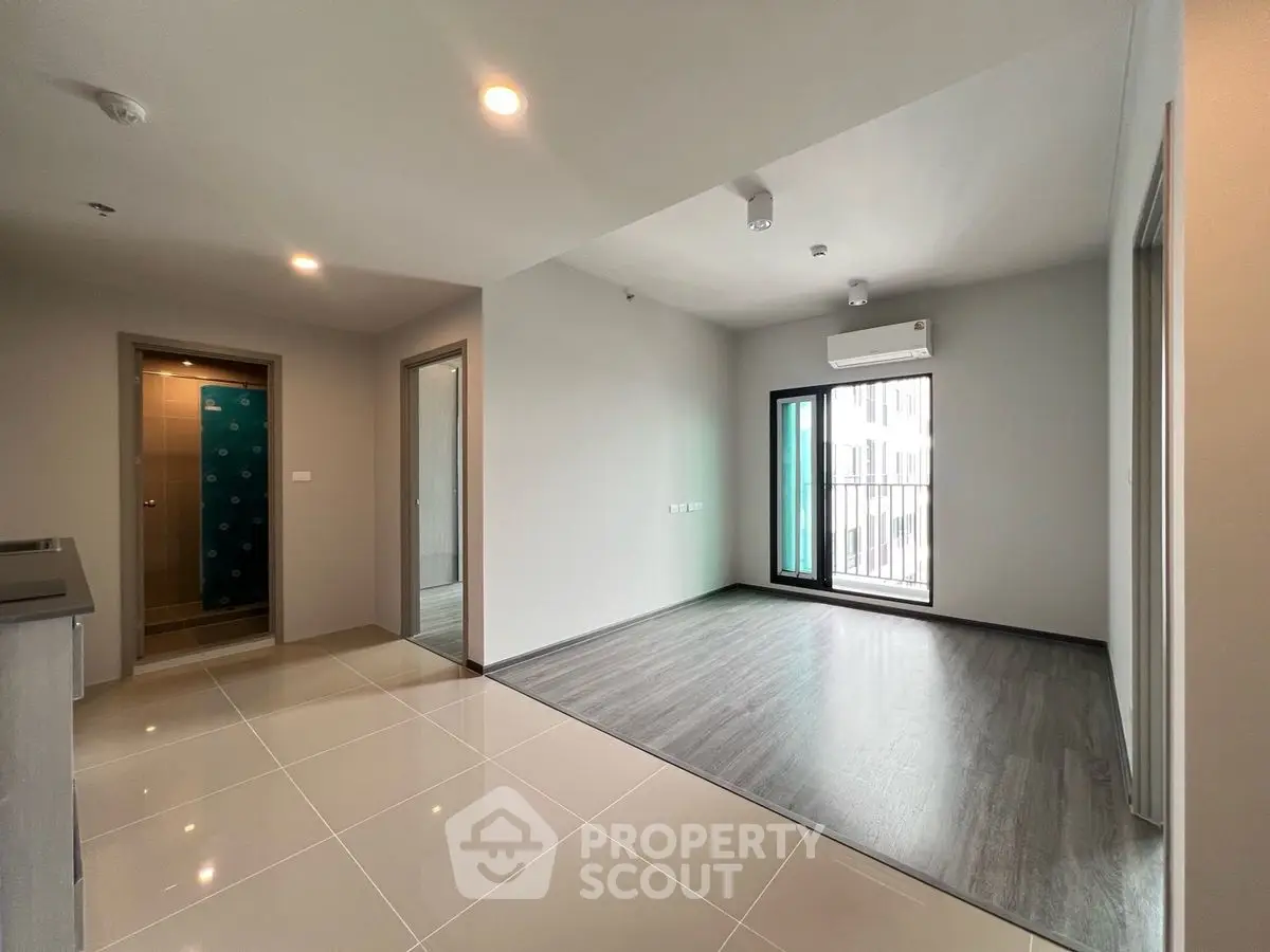 Modern apartment interior with open layout and balcony access