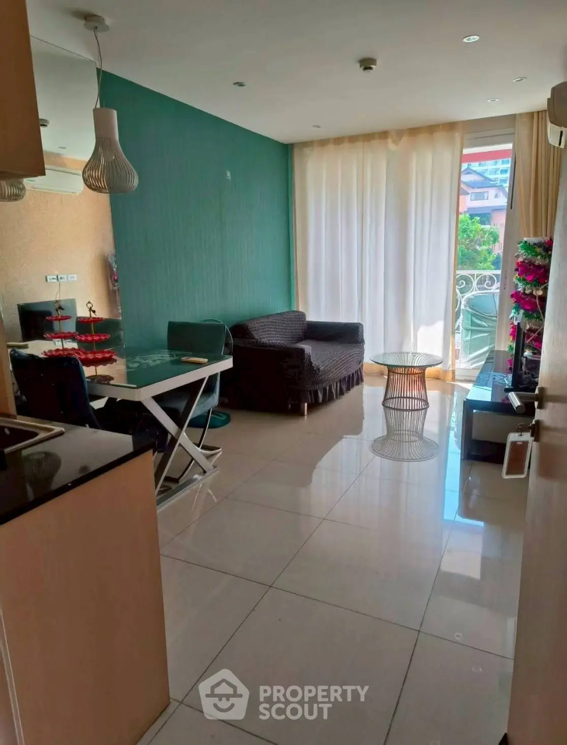 Modern living room with dining area and balcony access in a stylish apartment.