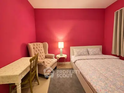 Cozy bedroom with vibrant pink walls, elegant armchair, and a comfortable bed, perfect for relaxation.
