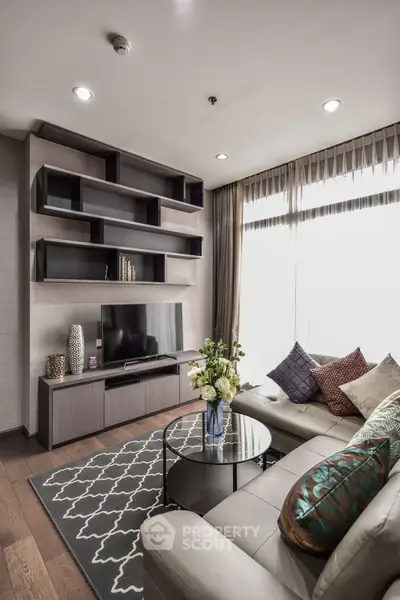 Modern living room with stylish shelving, cozy sofa, and elegant decor in a bright, inviting space.
