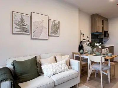 Modern living room with cozy sofa and dining area in open layout apartment