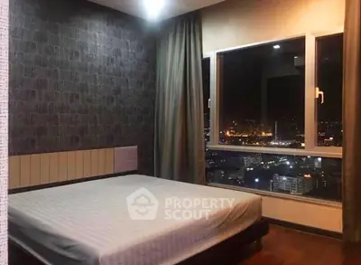 Stunning bedroom with city view, featuring large window and modern decor, perfect for urban living.