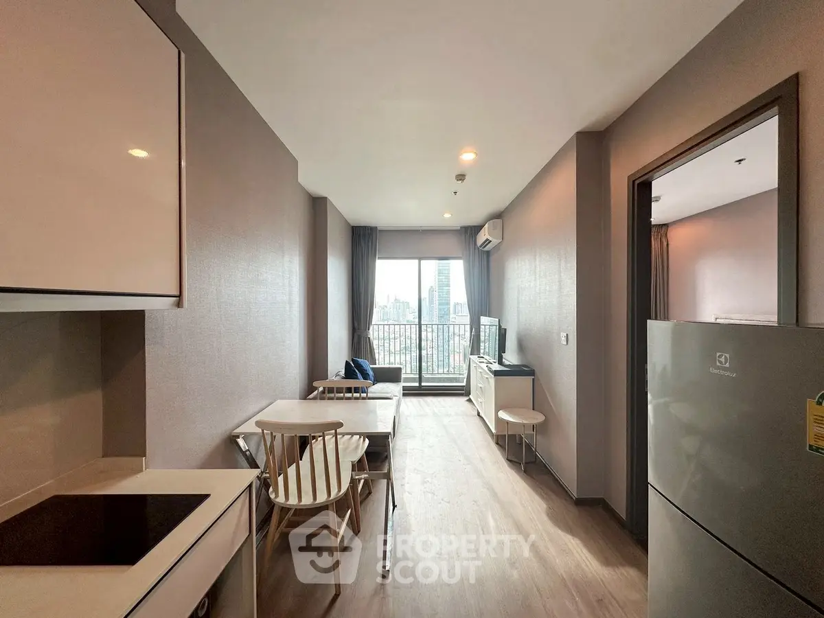 Modern living room with city view, featuring sleek furniture and open layout.