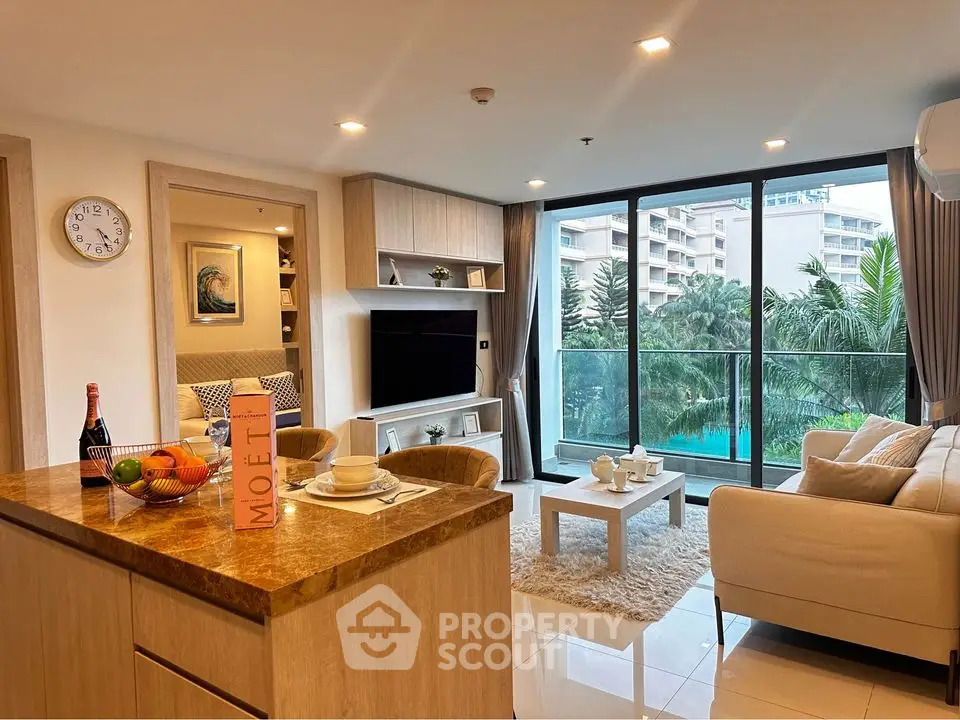 Luxurious living room with modern decor and pool view balcony in upscale apartment.