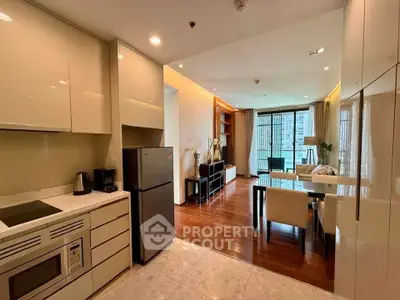 Modern open-layout kitchen and living room with sleek design and natural light.