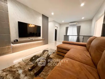 Spacious modern living room with luxurious leather sofa and sleek TV setup