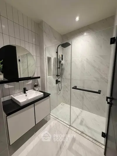 Modern bathroom with sleek shower and stylish vanity in luxury home