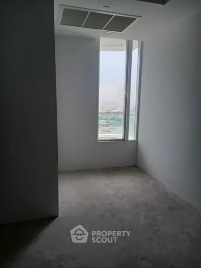 Minimalist empty room with large window and city view