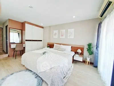 Spacious modern bedroom with cozy decor and natural light