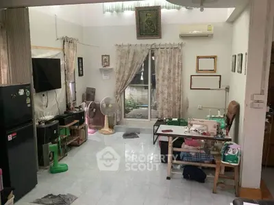 Spacious living area with sewing machine and modern appliances, ideal for creative living.
