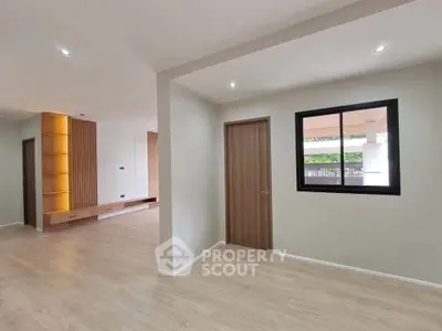 Spacious modern living room with wooden accents and large window