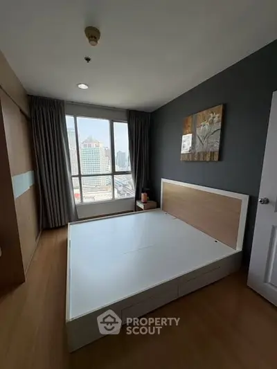 Spacious bedroom with city view and modern decor