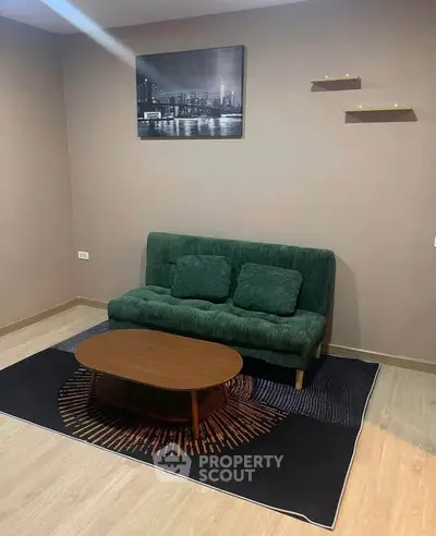 Cozy living room with green sofa and modern decor, perfect for relaxation.