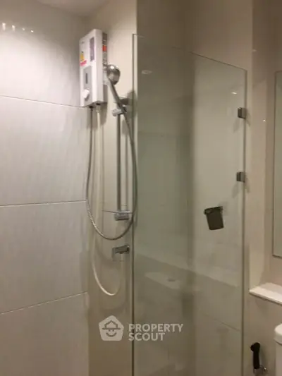 Modern bathroom with glass shower enclosure and sleek fixtures