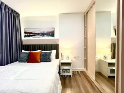 Modern bedroom with stylish decor and mirrored wardrobe