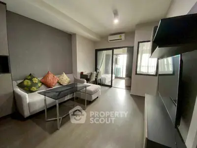 Modern living room with sleek design and large windows for natural light