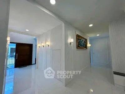 Elegant hallway with modern lighting and glossy white tiles