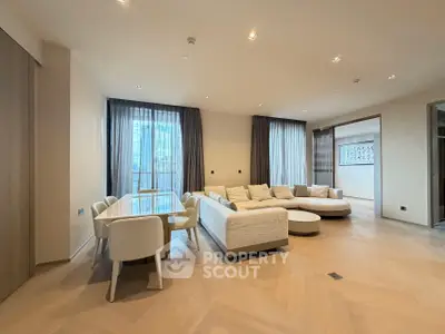 Spacious modern living room with elegant dining area and large windows.