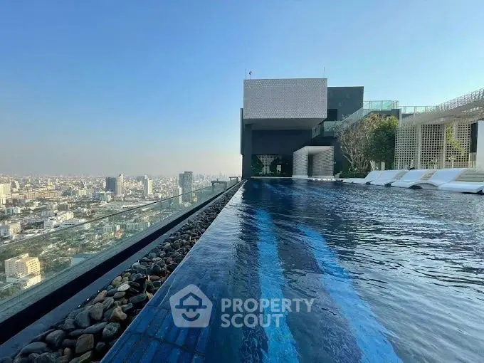 Luxurious rooftop pool with stunning city skyline view, perfect for relaxation and leisure.