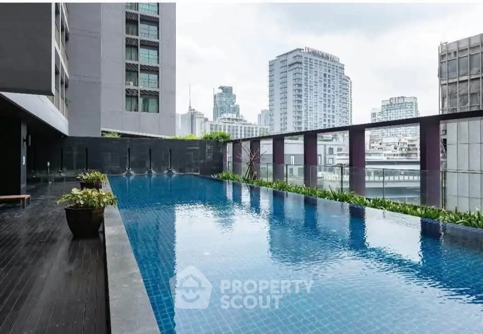 Luxurious rooftop pool with stunning cityscape views in modern urban building.