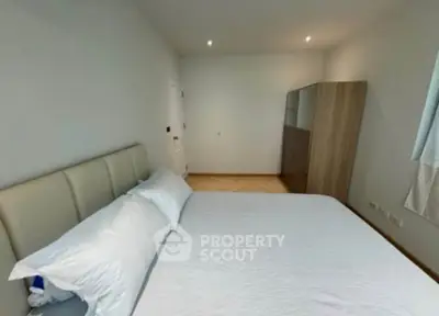 Spacious bedroom with modern decor and ample natural light