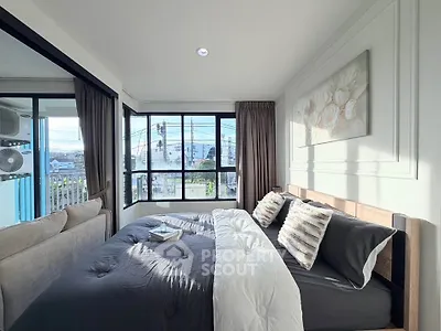 Bright and cozy bedroom with large windows and stylish decor