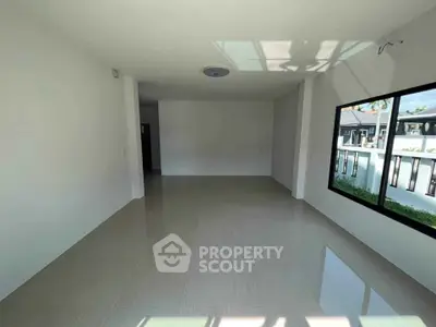 Spacious empty room with large window and glossy tiled floor, perfect for customization.